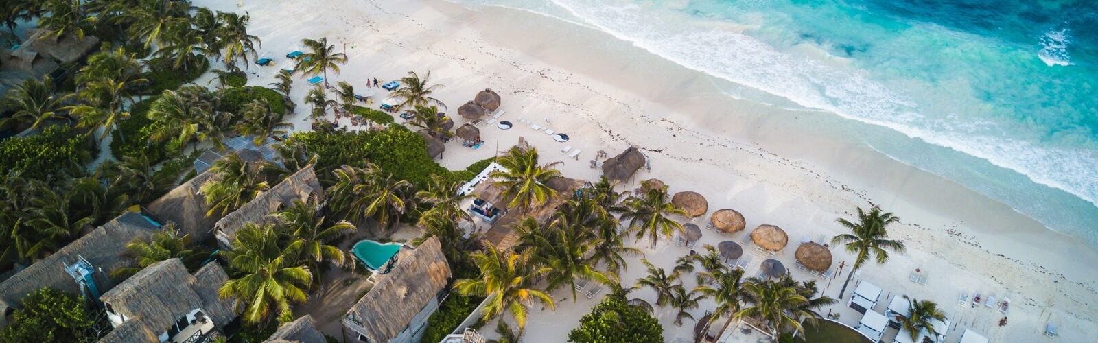 an above view of beach houses along the coast.