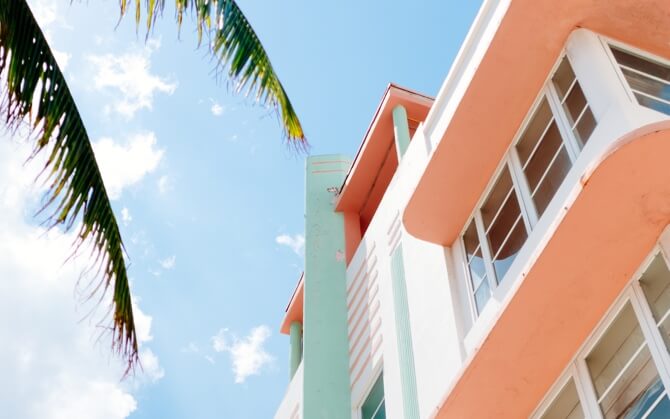 Looking up at a beach house with a clear blue sky.